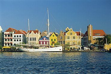 Ships moored in front of the colonial gabled waterfront buildings of Willemstad, UNESCO World Heritage Site, Curacao, West Indies, Caribbean, Central America