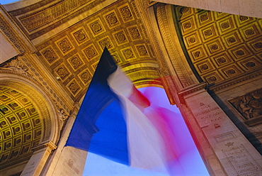 French flag flying at dusk, Arc de Triomphe, Paris, France, Europe