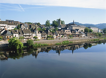 Reflections in the River Dordogne of houses and churches of Argentat in Correze, Limousin, France, Europe