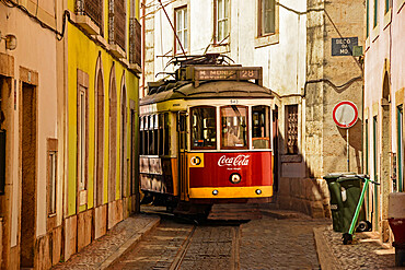 Tram on route 28 through the narrow streets of Alfama old town, Lisbon, Portugal, Europe