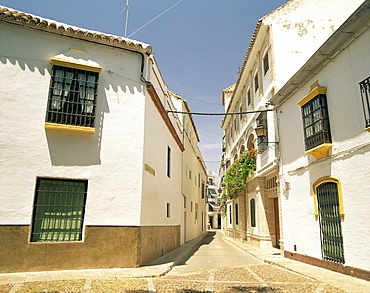 White walled houses on a narrow street in the village of Ecija, in the province of Seville, Andalucia, Spain, Europe