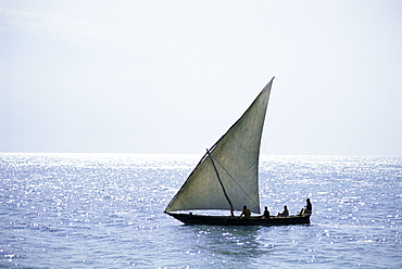 Dhow in silhouette on the Indian Ocean, off Stone Town, Zanzibar, Tanzania, East Africa, Africa