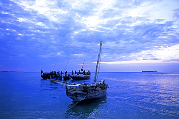 Fishing boats on the Indian Ocean at dusk, off Stone Town, Zanzibar, Tanzania, East Africa, Africa