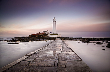 View along the tidal causeway to St. Mary's Island and St. Mary's Lighthouse at dusk, near Whitley Bay, Tyne and Wear, England, United Kingdom, Europe