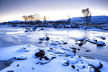 Dawn view of frozen Loch Ba on snow-covered Rannoch Moor, Highland, Scotland, United Kingdom, Europe