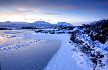 Dawn view of frozen Loch Ba on snow-covered Rannoch Moor, Highland, Scotland, United Kingdom, Europe