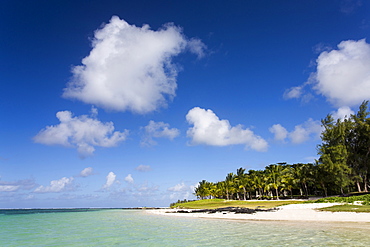 View of idyllic Belle Mare Beach showing blue sky, soft sand and the aquamarine sea of the Indian Ocean, near Centre De Flacq on the east coast of Mauritius, Indian Ocean, Africa