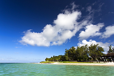 View of idyllic Belle Mare Beach showing blue sky, soft sand and the aquamarine sea of the Indian Ocean, near Centre De Flacq on the east coast of Mauritius, Indian Ocean, Africa