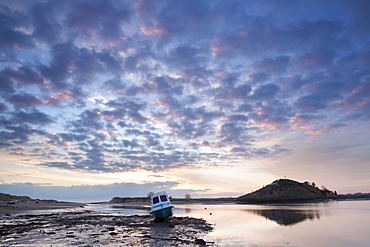 View towards Church Hill and the Aln Estuary during a stunning winter sunrise from the beach at low tide with a fishing boat in the foreground, Alnmouth, near Alnwick, Northumberland, England, United Kingdom, Europe