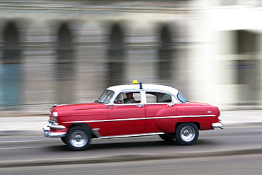 Panned shot of vintage American car on The Malecon, Havana, Cuba, West Indies, Caribbean, Central America