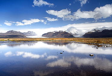 Mountains and glaciers on the edge of the Vatnajokull Ice Cap near Skaftafell National Park, reflecting in a nearby lake, South Iceland, Iceland, Polar Regions