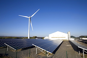 Three types of renewable electricity generation on Newton Down, wind turbine, solar panels and, in the shed, anaerobic digestion, Newton Down, Porthcawl, South Wales, United Kingdom, Europe