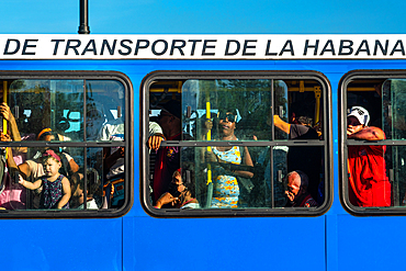 People in packed public bus seen through windows, Havana, Cuba