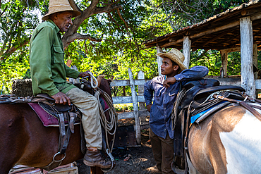 Cowboys in discussion, with their horses, at a farm near Trinidad, Cuba 2 (2 Model releases)