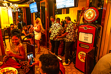 Salsa band and singer plays in retro restaurant, Old Havana, Cuba