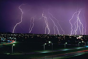 Fork lightning at night over a city