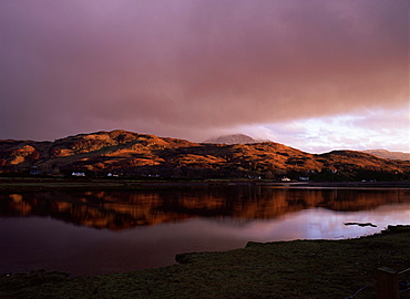 Dusk over Glenelg village with last rays of sun on hills reflected in the Glenmore River estuary at high tide, Glenelg, Highlands, Scotland, UK, Europe