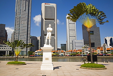 Sir Stamford Raffles statue and travellers palm at Raffles Landing Site on North Boat Quay of River with skyscrapers of Raffles Place in downtown Central Business District beyond, Marine Parade, Singapore, Southeast Asia, Asia