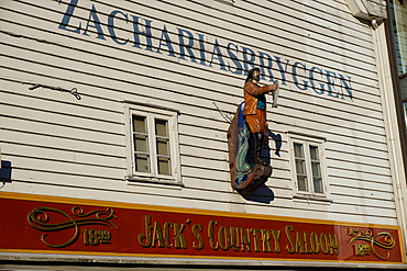 Statue of man holding fish, Bryggen, Bergen, Hordaland, Norway, Scandinavia, Europe