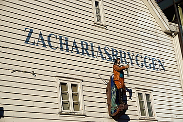 Statue of man holding fish, Bryggen, Bergen, Hordaland, Norway, Scandinavia, Europe