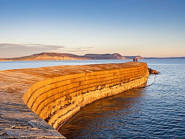 People at the end of The Cobb enjoying the evening light, Lyme Regis, Dorset, England, United Kingdom, Europe