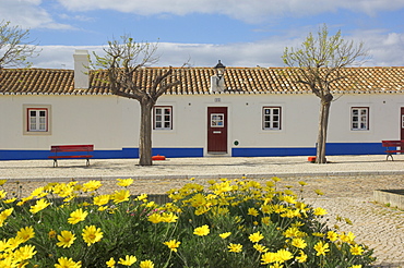 Traditional white and blue painted cottages in village centre, Porto Cova, Beja district, West Portugal, Europe