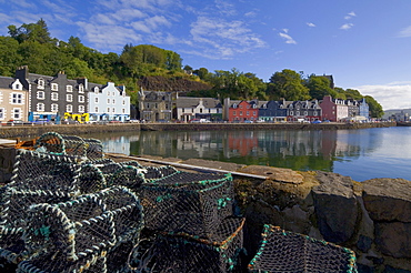 Multicoloured houses, and lobster pots on the jetty, in the harbour at Tobermory, Balamory, Mull, Inner Hebrides, Scotland, United Kingdom, Europe