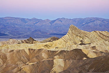 Manly Beacon and the Siltstone eroded foothills formations at Zabriske Point at sunrise, Furnace creek, Death Valley National Park, California, United States of America, North America