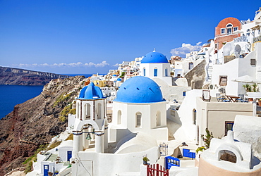 Greek church with three blue domes in the village of Oia, Santorini (Thira), Cyclades Islands, Greek Islands, Greece, Europe