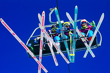 France, Alps, Haute-Savoie, Avoriaz In Winter, Skers On A Chairlift Seen From Below