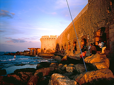 Egypt, Alexandria, The Qait Bay Turkish Fortress At Dusk, Fisherman