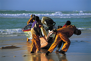 Senegal, Saintlouis, Fishermen & Outrigger On The Beach