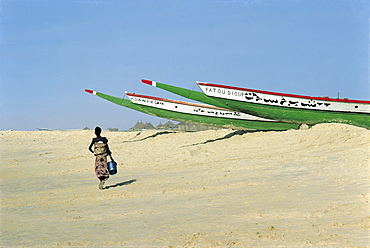 Senegal, Cayar, Fishing Outriggers Ashore, Woman Walking On The Beach, 