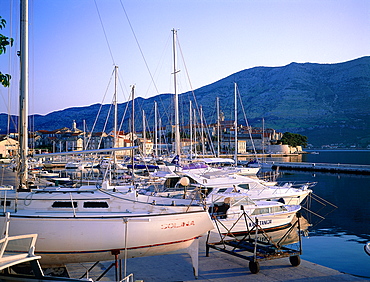 Croatia, Dalmatia, Dalmatian Coast, Korcula Island, Boats At The Marina And At Back The Fortified City Ramparts