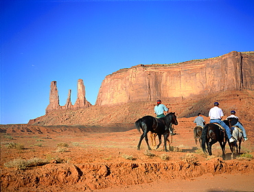 Usa, South West, Arizona & Utah, Navajo Reservation Of Monument Valley, The Three Sisters Red Rocks Peaks (Mesas), Tourist Visiting On Horseback