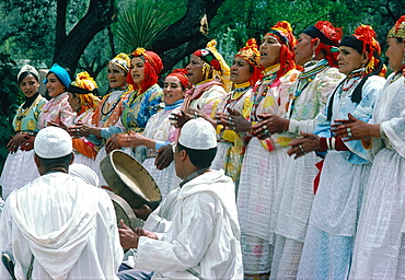 Morocco, Atlas Mountains, Near Marrakech In Asni Village Women Performing Traditional Dances And Songs, Two Men Seated Playing Drums