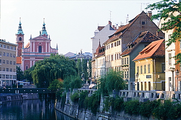 Slovenia, Ljubljana (Lubiana), Classic Housing Building Along The River Ljubljanica, Church At Back