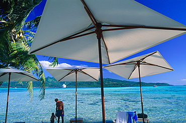 French Polynesia, Leeward Islands, Tahaa Island, Landscape And White Sunshades At Fore