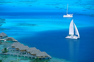 French Polynesia, Leeward Islands, Borabora And Lagoon, Aerial Of Huts On Piles And Sailing Boat