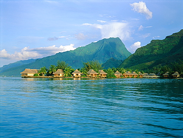 French Polynesia, Windward Islands, Moorea, View From Lagoon At Dusk Of Hotel Beachcomber Cabins On Piles