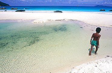 Seychelles, Praslin Island, River Mouth In The Lagoon, Young Local Boy Passing By