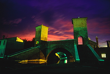 Italy, Emilia Romagna, River Po Delta, Comarchio, The Famous Bridge With Towers At Dusk