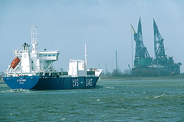 Netherlands, Rotterdam, The Harbour, Cargo Freighter Against Landscape Of Cranes