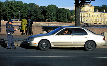 Russia, Saint Petersburg, Policeman Ticketing A Car Driver 