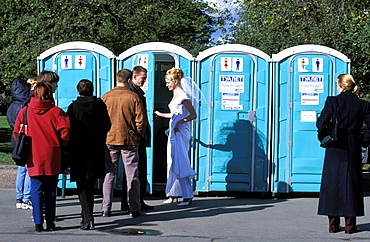 Russia, Saint Petersburg, Palace Square, Woman In Wedding Gown Entering Public Toilet 