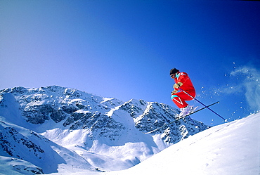 France, Alps In Winter, Skier Jumping On A Snow Bump 