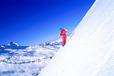 France, Alps In Winter, Expert Woman Skiing On A Very Steep Trail 