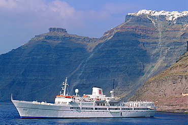 Greece, Cyclades, Santorini Island, In The Former Volcanic Caldera Cruise Boat Anchored, The White Ia Village On To P Of Hill Behind