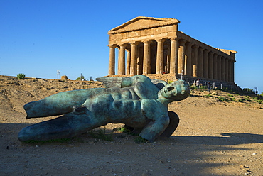 Modern sculpture of Icarus in front of the Temple of Concordia, Valley of the Temples, Agrigento, UNESCO World Heritage Site, Sicily, Italy, Europe