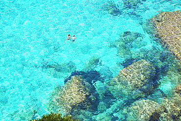 People swimming in the emerald waters of Cala Mitjana, Menorca, Balearic Islands, Spain, Mediterranean, Europe